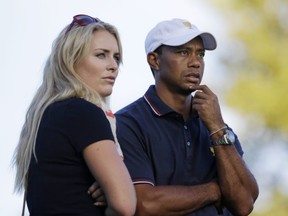 United States' Tiger Woods watches the 17th hole with his girlfriend Lindsey Vonn during the four-ball matches at the Presidents Cup golf tournament at Muirfield Village Golf Club Thursday, Oct. 3, 2013, in Dublin, Ohio. (AP Photo/Darron Cummings)