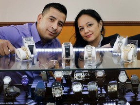 Joel Gonzalez with wife Cindy David in his new watch repair shop in Dollard-des-Ormeaux. (Allen McInnis/THE GAZETTE)