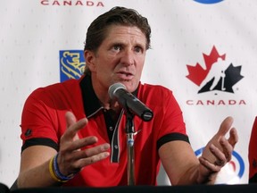 Head coach Mike Babcock, of Saskatoon, Sask., speaks to reporters at the Canadian national men's team orientation camp in Calgary, Alta., on Sunday, Aug. 25, 2013. THE CANADIAN PRESS/Jeff McIntosh