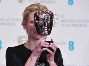 Peek-a-boo! Australian actress Cate Blanchett poses with the Best Actress Award for her work on the film Blue Jasmine at the BAFTA British Academy Film Awards at the Royal Opera House in London on February 16, 2014. (CARL COURT/AFP/Getty Images)