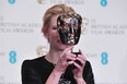 Peek-a-boo! Australian actress Cate Blanchett poses with the Best Actress Award for her work on the film Blue Jasmine at the BAFTA British Academy Film Awards at the Royal Opera House in London on February 16, 2014. (CARL COURT/AFP/Getty Images)