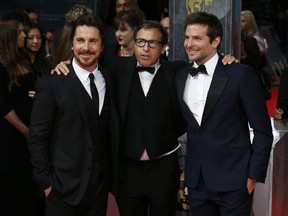 Actor Christian Bale (L), director David O. Russell (C) and  actor Bradley Cooper (R) arrive on the red carpet for the BAFTA British Academy Film Awards at the Royal Opera House in London on February 16, 2014. (ANDREW COWIE/AFP/Getty Images)