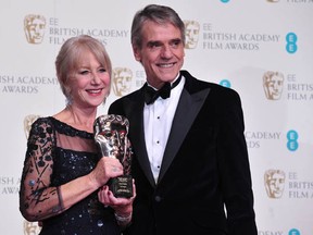 British actress Helen Mirren (L) poses with the academy fellowship award with presenter British actor Jeremy Irons (R) at the BAFTA British Academy Film Awards at the Royal Opera House in London on February 16, 2014. (CARL COURT/AFP/Getty Images)