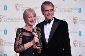 British actress Helen Mirren (L) poses with the academy fellowship award with presenter British actor Jeremy Irons (R) at the BAFTA British Academy Film Awards at the Royal Opera House in London on February 16, 2014. (CARL COURT/AFP/Getty Images)