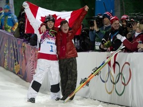 Canadian Alex Bilodeau, left, celebrates his win gold medal win with his brother Frederic following the moguls finals at the Sochi Winter Olympics in Krasnaya Polyana, Russia, Monday, Feb. 10, 2014. THE CANADIAN PRESS/Jonathan Hayward