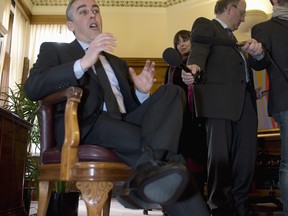 Quebec Finance Minister Nicolas Marceau displays his new shoes as he responds to reporters questions during a photo opportunity in his office Tuesday in Quebec City. Marceau’s budget, tabled Thursday afternoon, is expected to be the first step towards a spring election in Quebec. THE CANADIAN PRESS/Jacques Boissinot