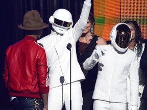 LOS ANGELES, CA - JANUARY 26:  (L-R) Musicians Pharrell Williams, with Thomas Bangalter and Guy-Manuel De Homem-Christo of Daft Punk, accept the Record of the Year award for 'Get Lucky' onstage during the 56th GRAMMY Awards at Staples Center on January 26, 2014 in Los Angeles, California.  (Photo by Kevork Djansezian/Getty Images)