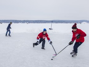 Left to right: Erik Thijs, Matthias Thijs and Alex Remington play hockey as they warm up for a game of shinny on the Lake of Two Mountains near Hudson on Sunday, February 2, 2014.