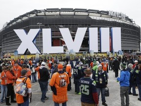 Fans arrive for the NFL Super Bowl XLVIII football game between the Seattle Seahawks and the Denver Broncos at MetLife Stadium Sunday, Feb. 2, 2014, in East Rutherford, N.J. (AP Photo/Seth Wenig)