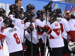 Canada's players celebrate after winning the Women's Ice Hockey semifinal match Canada vs Switzerland at the Shayba Arena during the Sochi Winter Olympics on February 17, 2014. Canada won 3-1.   AFP PHOTO / JONATHAN NACKSTRANDJONATHAN NACKSTRAND/AFP/Getty Images