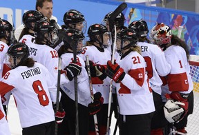 Canada's players celebrate after winning the Women's Ice Hockey semifinal match Canada vs Switzerland at the Shayba Arena during the Sochi Winter Olympics on February 17, 2014. Canada won 3-1.   AFP PHOTO / JONATHAN NACKSTRANDJONATHAN NACKSTRAND/AFP/Getty Images