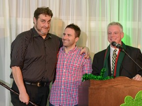 Comedian Joey Elias accepts his shillelagh during the parade Grand Marshal's gala on Friday, Feb. 21, as the evening's master of ceremonies, Ken Doran (right) looks on.