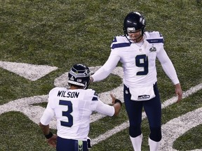 EAST RUTHERFORD, NJ - FEBRUARY 02:  quarterback Russell Wilson #3 and punter Jon Ryan #9 of the Seattle Seahawks celebrates against the Denver Broncos during Super Bowl XLVIII at MetLife Stadium on February 2, 2014 in East Rutherford, New Jersey.  (Photo by Jeff Zelevansky/Getty Images)