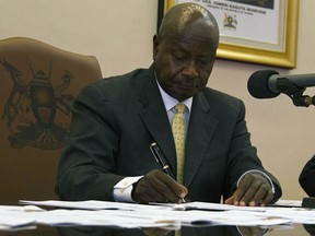 Ugandan President Yoweri Museveni signs draconian anti-homosexuality bill on February 24, 2014 in Entebbe. The bill that was first tabled back in 2009 will see offenders, if convicted, serve a life imprisonment. President Museveni went on to say that he won't let Uganda citizens be forced into such behaviours by Western society.  (ISAAC KASAMANI/AFP/Getty Images)