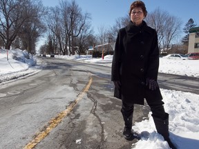 Heather Allard stands at the corner of Lake and Herron in Dorval on Sunday. The city is doing a traffic study about speeding on the corner.