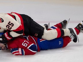 Ottawa Senators right wing Chris Neil, top, pins Montreal Canadiens left wing Max Pacioretty to the ice and drives his face into the ice surface during NHL action at the Bell Centre in Montreal on Saturday March 15, 2014. (Allen McInnis / THE GAZETTE)