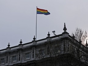 The rainbow flag flies over the British government Cabinet Office's building in central London, Friday, March 28, 2014, to mark the start of same-sex weddings in the UK . (AP Photo/Lefteris Pitarakis)