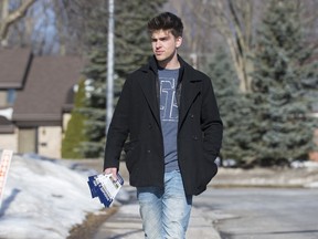 Connor Walsh walks with Scholars at Your Service pamphlets near his Pointe-Claire house, March 21, 2014.