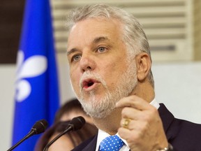 Liberal leader Philippe Couillard campaigning at a window manufacturing plant Friday in Blainville. THE CANADIAN PRESS/Ryan Remiorz