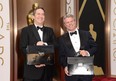 These guys have the answers! PricewaterhouseCoopers representatives have the Oscar envelopes in their briefcases, on March 2, 2014 in Hollywood, California.  (Jason Merritt/Getty Images)