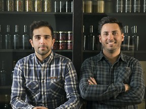 Alex Cruz, left, and Cyril Gonzales at the
Société Orignal warehouse, refrigeration
facility and office on Fullum St. (Photo by Dario Ayala)