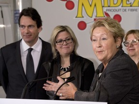 Parti Quebecois Leader Pauline Marois responds to reporters questions at a news conference, Thursday, March 13, 2014 in Levis. Marois took on the questions intended for St-Jerome candidate Pierre Karl Peladeau (at left). Quebecers are going to the polls on April 7. THE CANADIAN PRESS/Jacques Boissinot