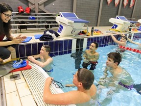Swim coach Jen Ward talks to 12-14-years-old age group swimmers at the Pointe Claire Aquatic Centre.
