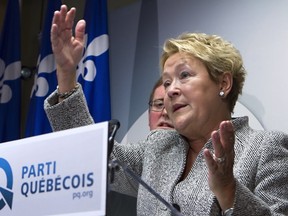 Quebec Premier Pauline Marois gestures as she announces the party's stand on the provincial debt on Wednesday March 12, 2014 in Quebec City. One week into a campaign that was supposed to be about identity and language, the debate is turning increasingly toward the possibility and consequences of another referendum on Quebec separation. THE CANADIAN PRESS/Clement Allard