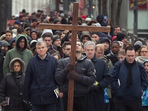 The Way of the Cross procession walks along Beaver Hall Hill near Viger, during the Good Friday ceremony in downtown Montreal on Friday April 18, 2014.