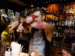 A bartender mixes it up at La Distillerie. (Photo courtesy of Invasion Cocktail)