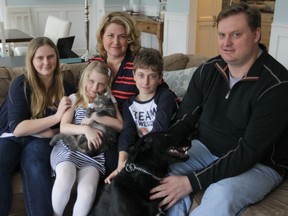 Liberal voters Danielle Delaney and Andrew Middleton never want their children, from left, Gabrielle, Mia and Philip, to "feel they have to leave the province for opportunity."
