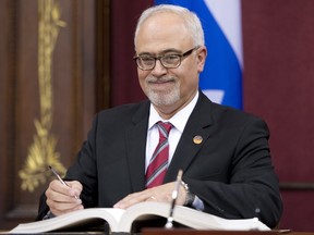 Quebec Finance Minister Carlos Leitao is sworn in during a ceremony, Wednesday, April 23, in Quebec City.