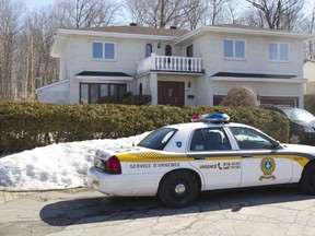SQ car is parked in front of former Montreal city manager Robert Abdallah's house in Pierrefonds on Wednesday, April 9, 2014, as the premises is searched by UPAC agents.