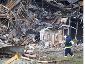 Nov. 9, 2012: A man walks through the site where a fire destroyed part of Neptune Technologies and Bioressources Inc. in Sherbrooke.