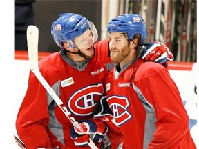 Alex Galchenyuk, who made the Canadiens as an 18-year-old for the 2012-13 season, puts his arm around teammate Brandon Prus.