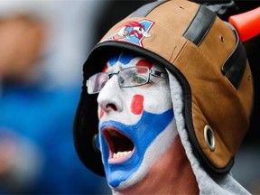 An Alouettes fan enjoys a home game last season at Molson stadium. Despite the windfall of new television money coming, the CFL remains a gate-driven league that needs to keep its costs down.