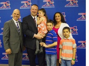 Alouettes president Mark Weightman, left, is photographed with Alouettes veteran player Scott Flory, (second from left) and his family: his wife Natasha (right), and their three kids, Ava and two sons Tyrus and Elia, far right.