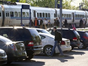 Passengers wait to board an AMT train at the Roxboro-Pierrefonds train station, May 20.