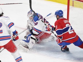 Brian Gionta of the Montreal Canadiens looks for a rebound as Henrik Lundqvist of the New York Rangers makes a save in the Eastern Conference Final of the NHL playoffs at the Bell Centre in Montreal on Saturday.