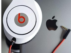 Beats Monster headphones sit on an Apple iPad Mini. According to media reports, Apple is going to acquire 100 per cent of Beats Electronics for $3.2 million. Beats Electronics is the company behind the critically acclaimed Beats headphones and is also the owner of Beats Music, a streaming music service that is the principal competitor of Apple's iTunes and Spotify.