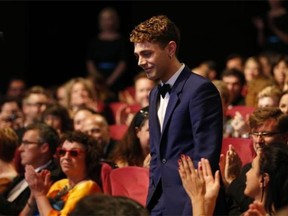 Canadian director Xavier Dolan smiles after being awarded with the Jury’s Prize during the closing ceremony of the 67th edition of the Cannes Film Festival in Cannes, France, on May 24, 2014.