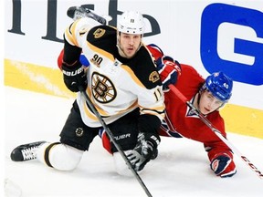 Canadiens defenceman Nathan Beaulieu, right, falls to the ice with Boston Bruins Gregory Campbell in third period of Game 6 of Stanley Cup playoff series in Montreal Monday May 12, 2014.
