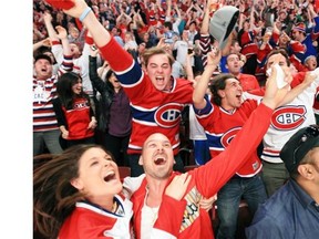 Canadiens fans celebrate their team’s victory over the Boston Bruins while watching Game 7 of Stanley Cup series on the big screens at the Bell Centre in Montreal Wednesday May 14, 2014.
