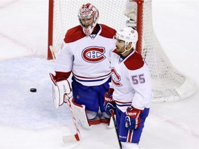 Canadiens goalie Carey Price (31) and defenceman Francis Bouillon watch as Boston Bruins centre Patrice Bergeron (37) celebrates after his goal during the third period of Game 2 in the second-round of the Stanley Cup hockey playoff series in Boston, Saturday, May 3, 2014.