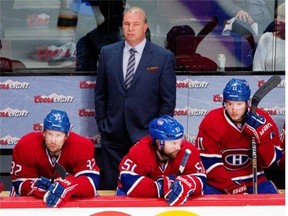 Canadiens head coach Michel Therrien and left-winger Travis Moen, left to right, centre David Desharnais and right-winger Brendan Gallagher watch the final moments during Game 4 against the Bruins Thursday night at the Bell Centre.