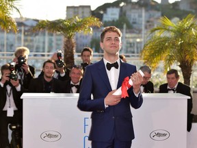 Xavier Dolan with the Jury Prize for his film Mommy at the Cannes Film Festival, on May 24, 2014. Look at that smiling photographer on the left, near Dolan's shoulder. Maybe he's always a cheerful guy, or maybe he's glad that the festival is almost over. I like to think that he's happy that Dolan won. While I'm imagining things, why not go further? Does Dolan have a 'looking into the future' expression here? Could he be thinking 'same time, next year!' Who knows? (Photo by Bertrand Langlois/AFP/Getty Images)