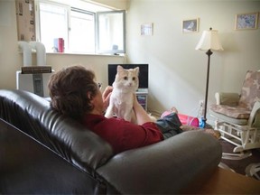 Cathy, a resident of La Maison Marguerite, a woman’s shelter in Montreal, with her cat Boo Boo, Monday May 26, 2014.
