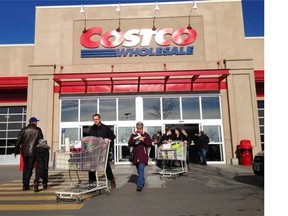 Customers walk out of Costco in Montreal on Saturday, Nov. 17, 2012. After the courts ruled that businesses that have storefront signs with their trademark name in a language other than French do not contravene the French Language Charter, the Liberal government has announced it will amend Bill 101 to force the addition of French descriptors. THE CANADIAN PRESS/Ryan Remiorz ORG XMIT: CPT107