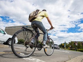 A cyclist rides on a cycling path under the Highway 40 at the northwest corner of Crémazie Boulevard and Christophe-Colomb Ave.