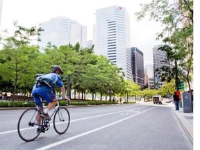 A cyclist rolls down a bicycle lane in downtown Montreal on August 13, 2010. A high-profile ticketing blitz, a string of deadly accidents, and a growing dispute over the rules of the road suggests Montreal is experiencing some growing pains as city cycling becomes more common.